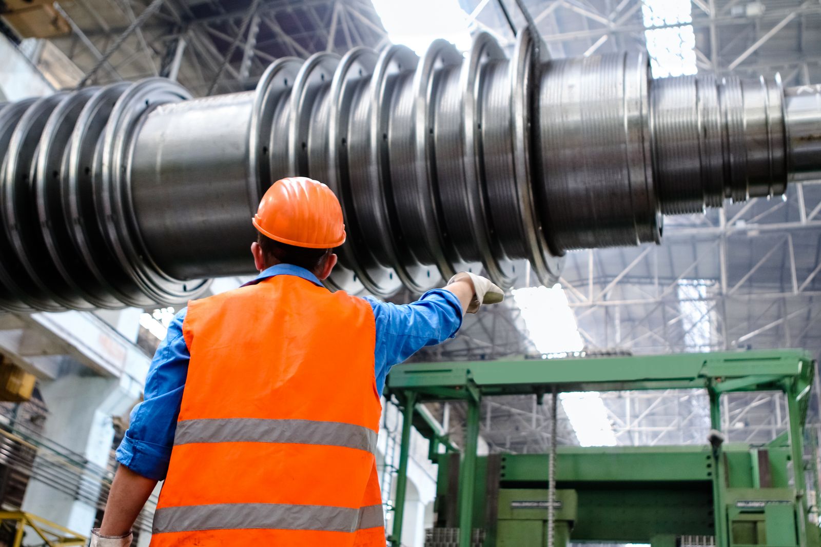 Technician inspecting heavy machined steel