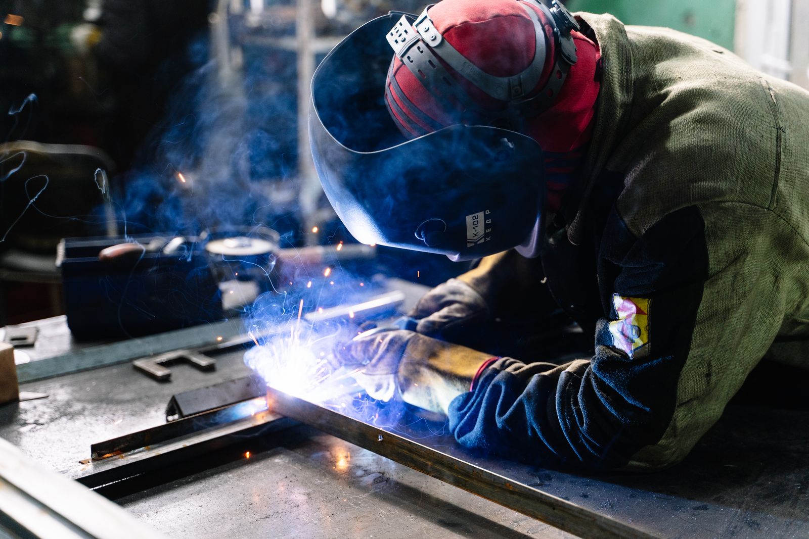 Welder sealing a steel defect under controlled sparks